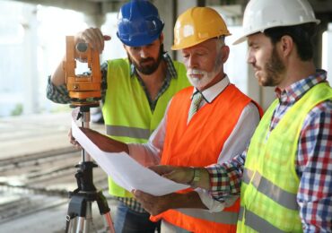 Architect and construction engineer or surveyor discussion plans and blueprints