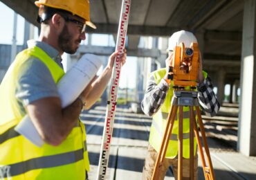 Portrait of construction engineers working on building site